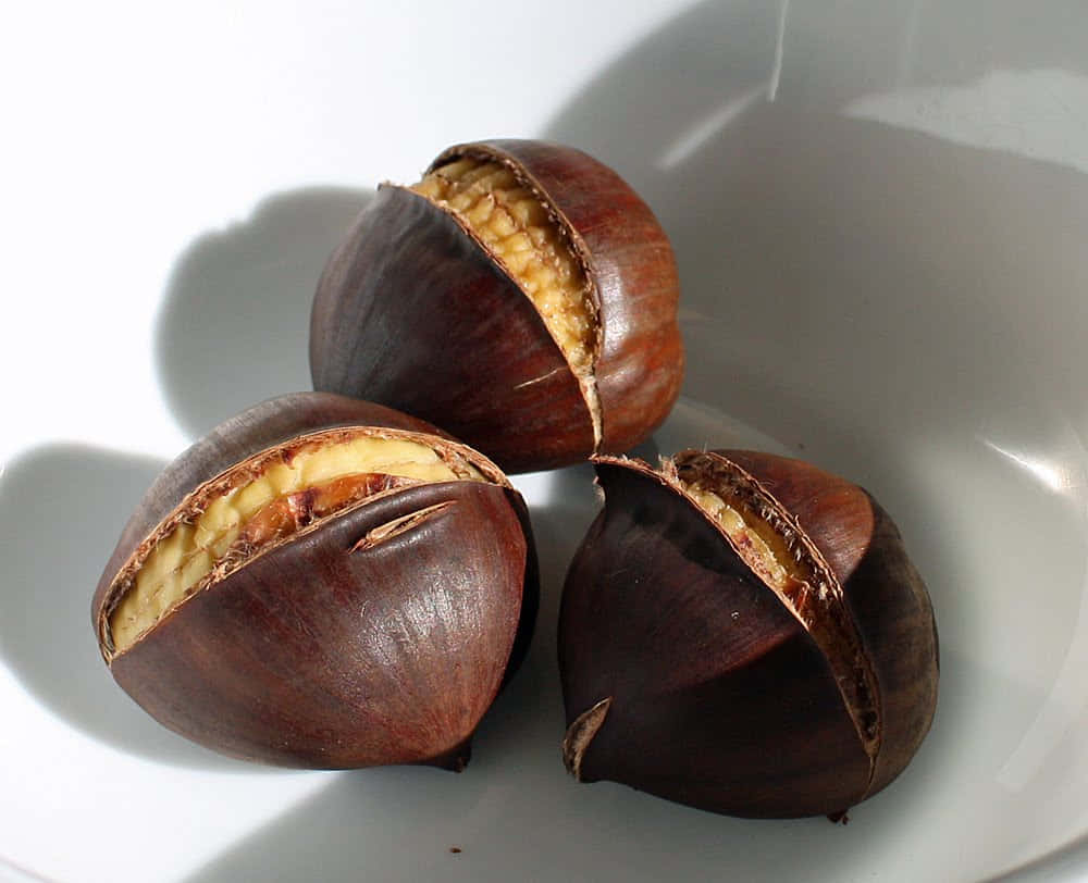 Autumn Chestnut On A Wooden Surface Wallpaper