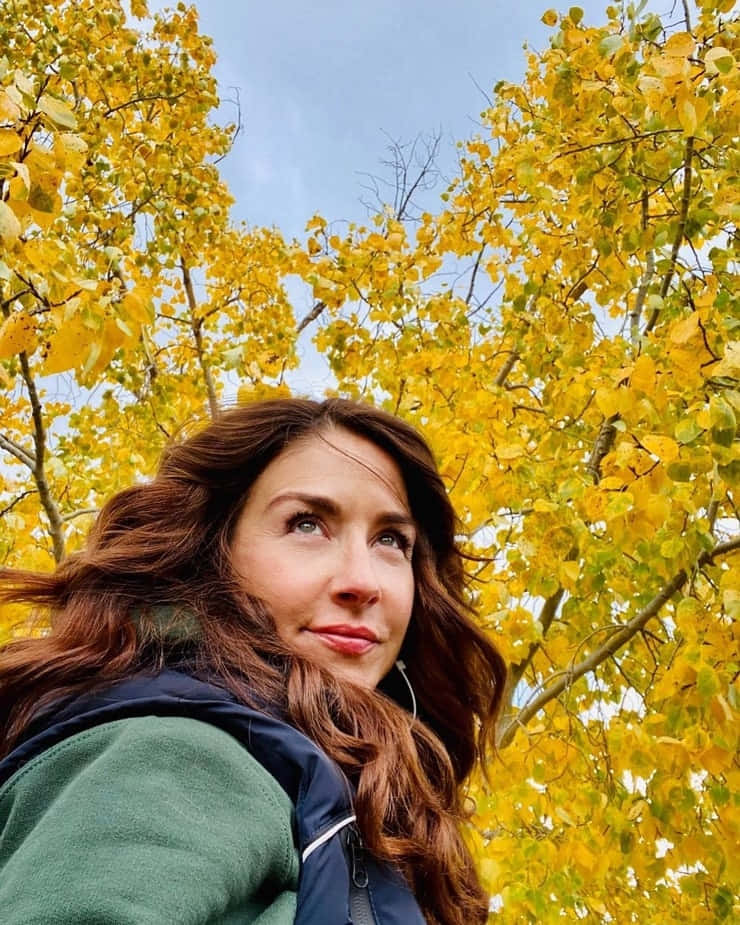 Autumn Gaze Woman Under Yellow Leaves Wallpaper