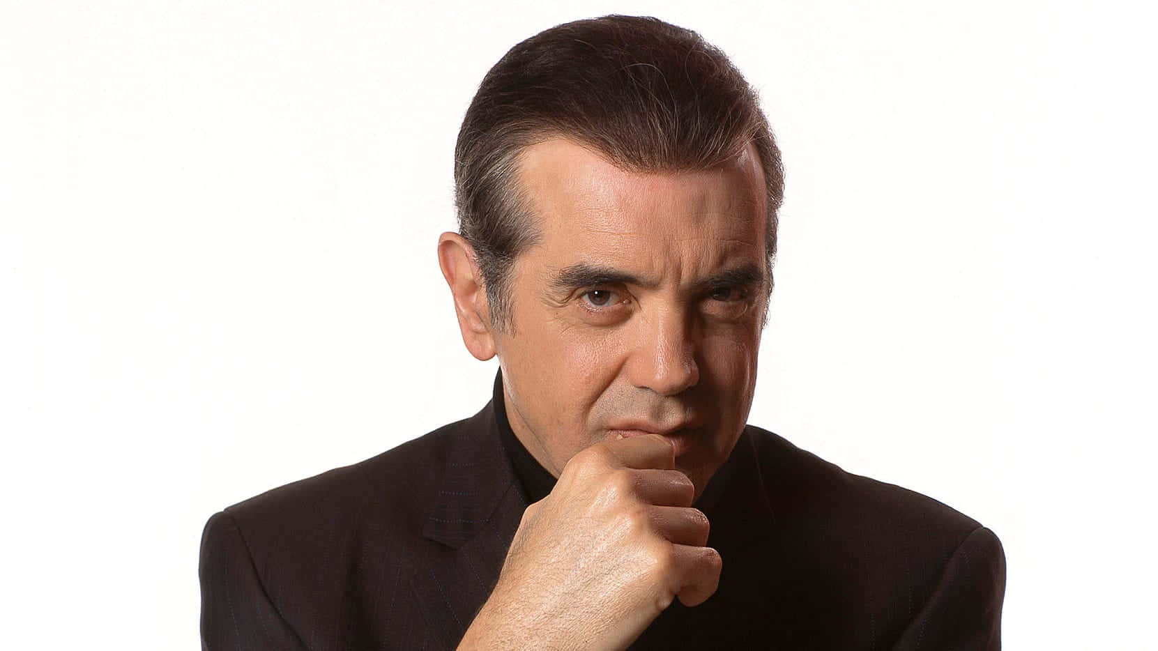 Award-winning Actor Chazz Palminteri Portraying Intensity In A Black And White Wallpaper Design Wallpaper