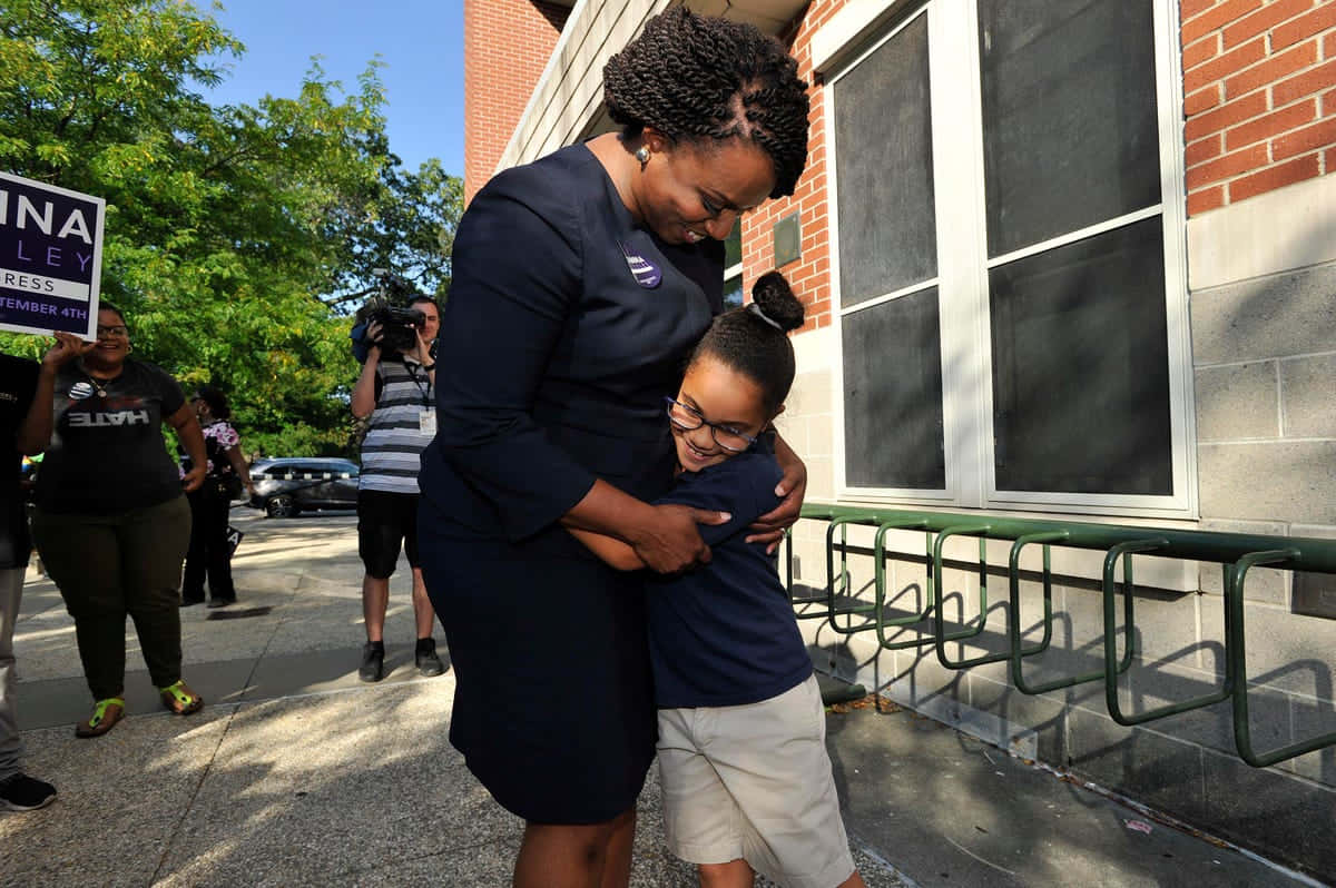 Ayanna Pressley Hugging Kid Wallpaper