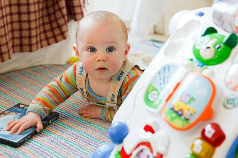 Baby Boy Crawling On The Floor Wallpaper