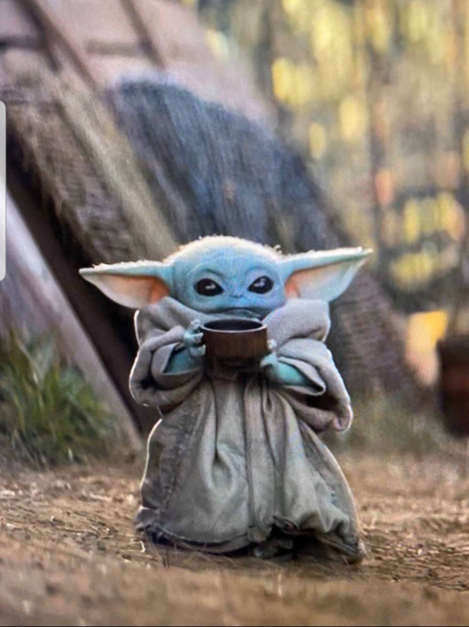 Baby Yoda Enjoys A Cup Of Tea Wallpaper