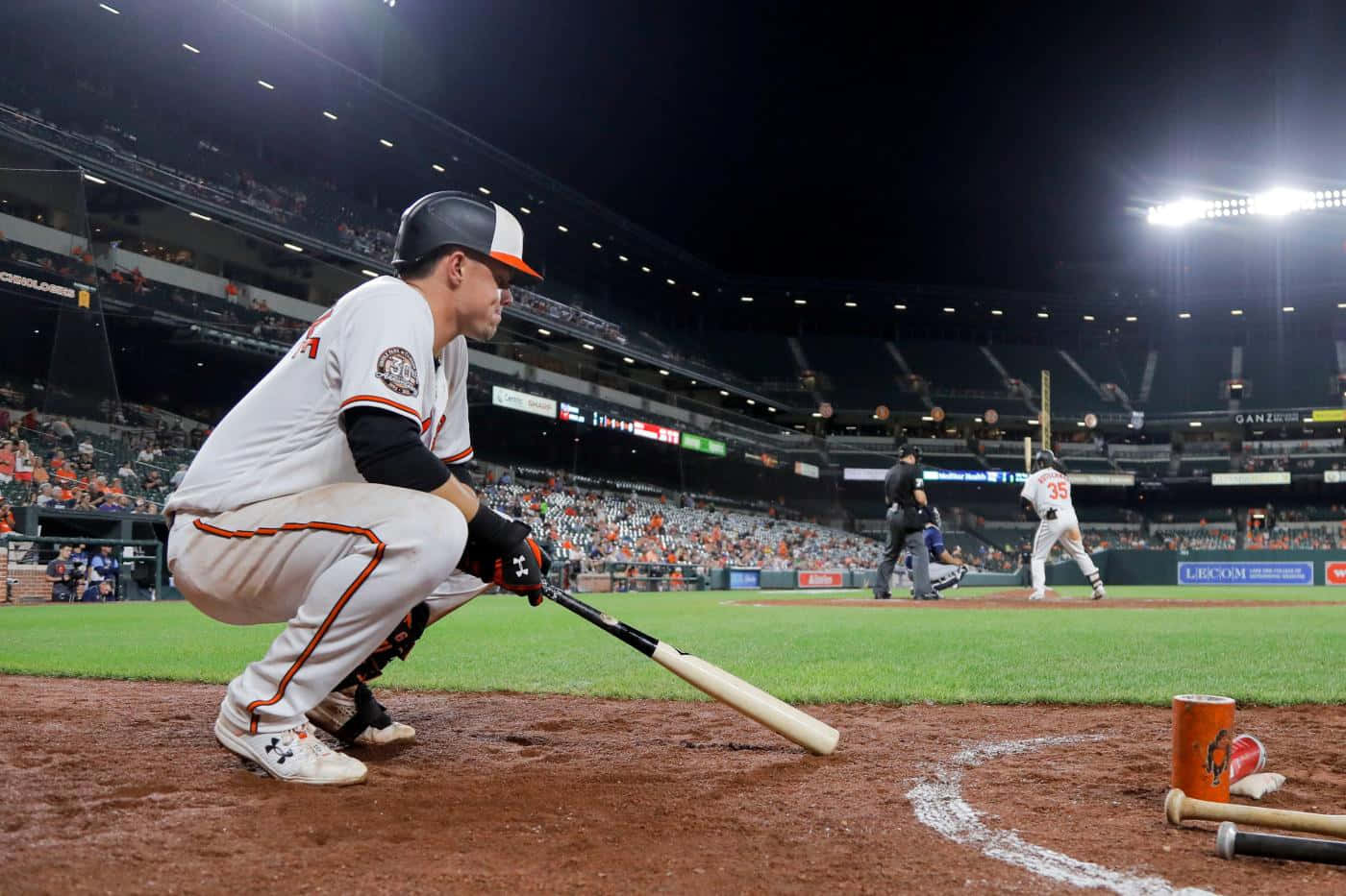 Baseball Player Crouching Near Bat Dugout Wallpaper