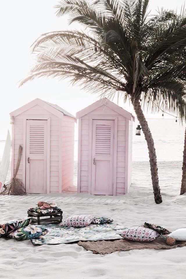 Beautiful Beach Huts Lined Up On A Sandy Shore Wallpaper