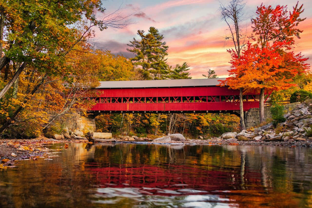 Beautiful Fall Bridge Amidst A Sea Of Autumn Hues Wallpaper