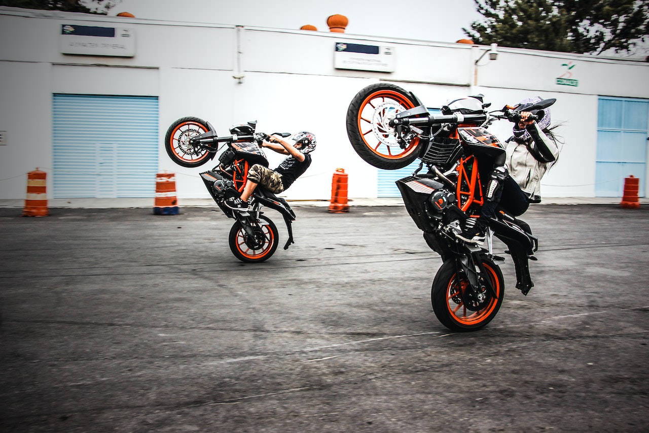 Bike Riders Hitting Wheelies Wallpaper