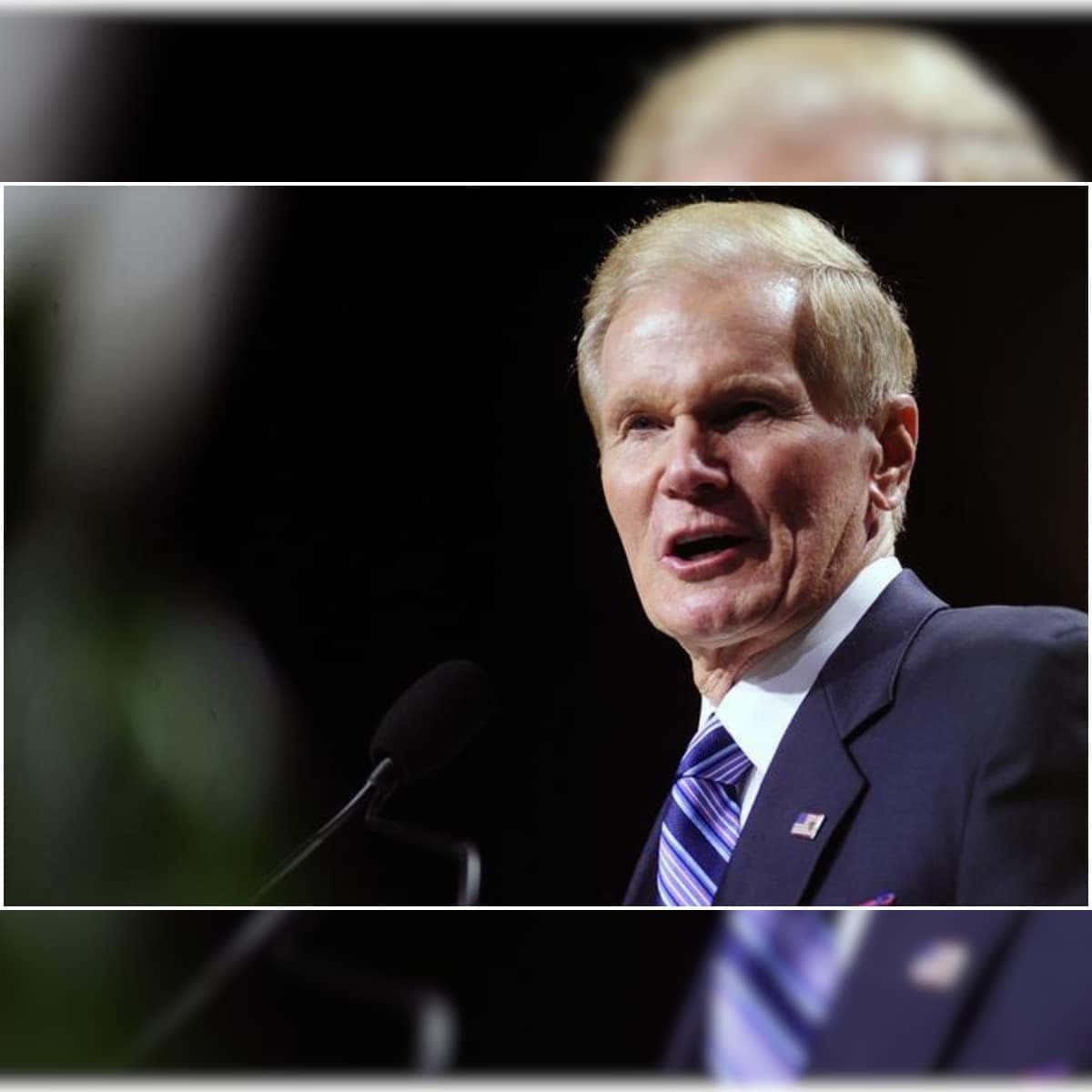 Bill Nelson In A Dark Blue Suit Square Wallpaper