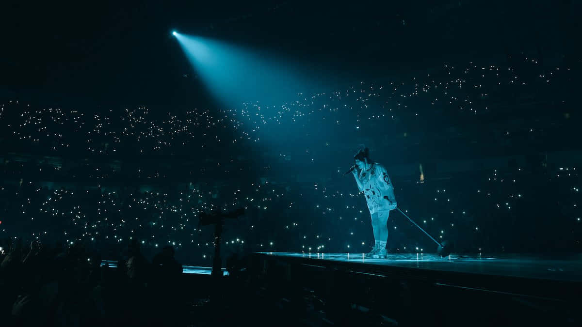 Billie Eilish Looking At Her Laptop Wallpaper