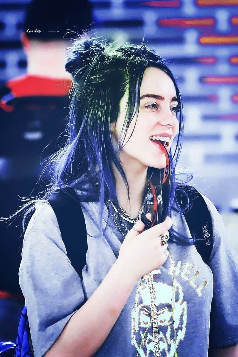 Billie Eilish Wearing A Content Smile Wallpaper