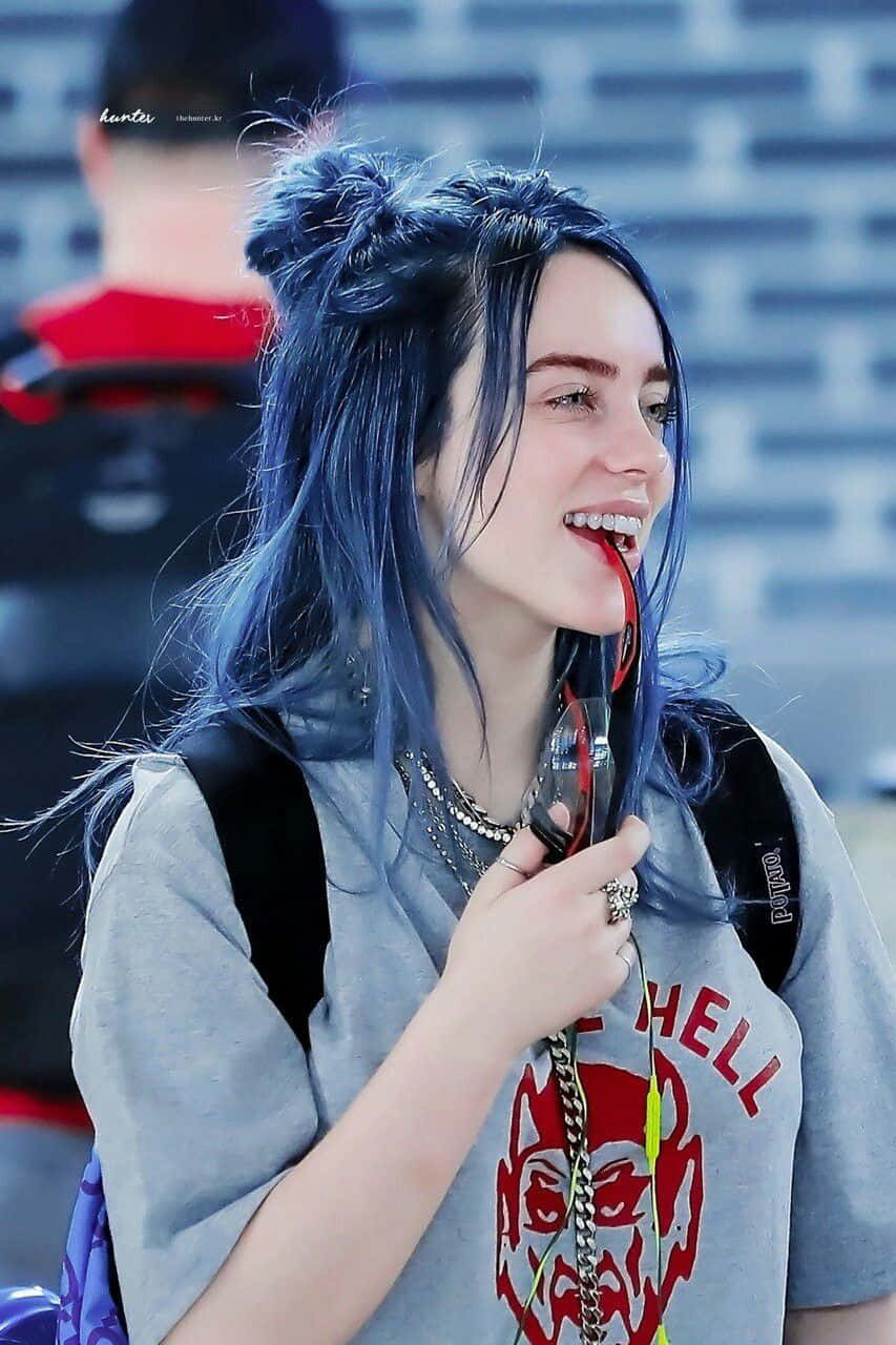 Billie Eilish Wearing Her Signature Smile Wallpaper