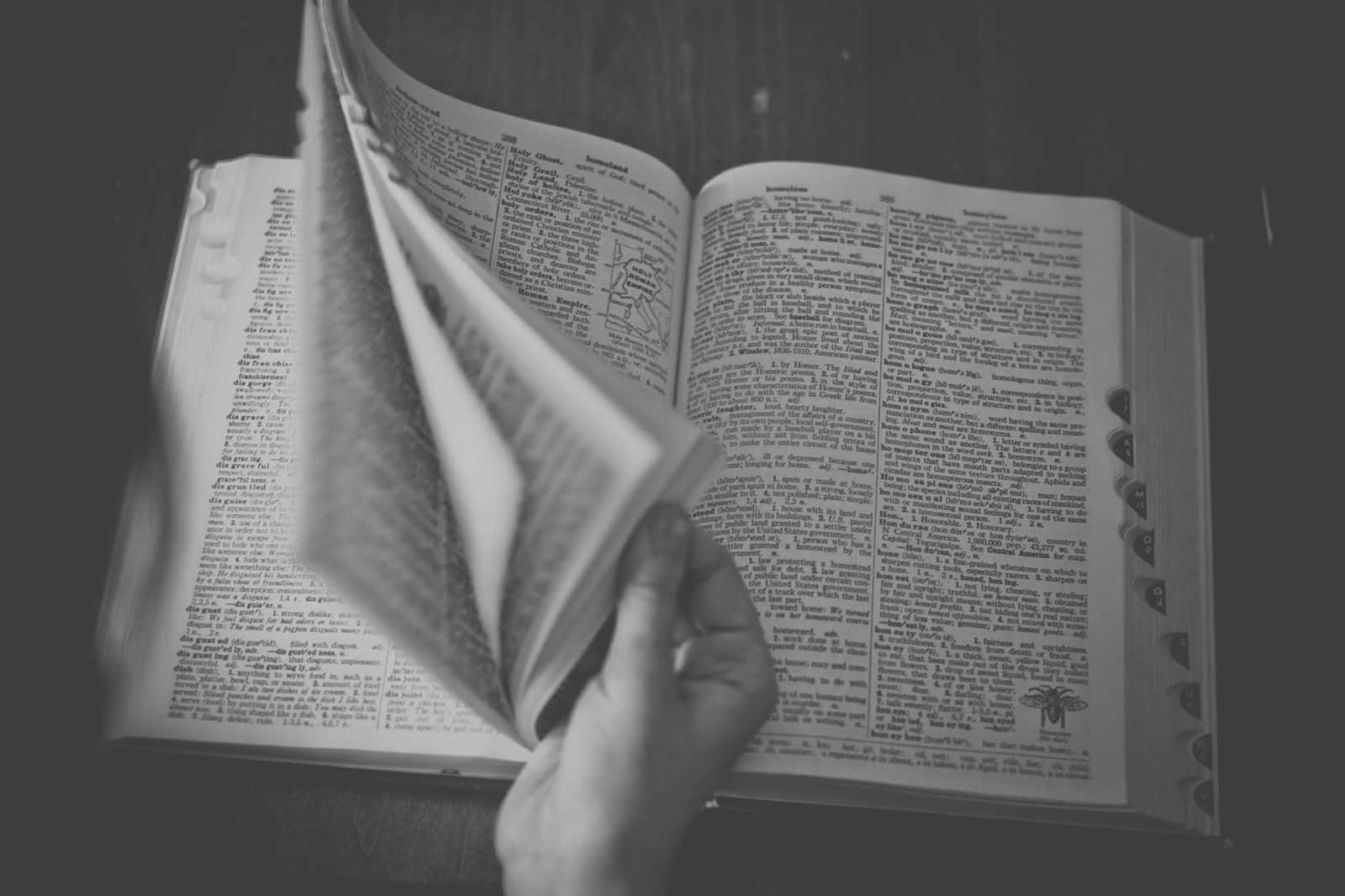 Black And White Open Book On Wooden Table Wallpaper