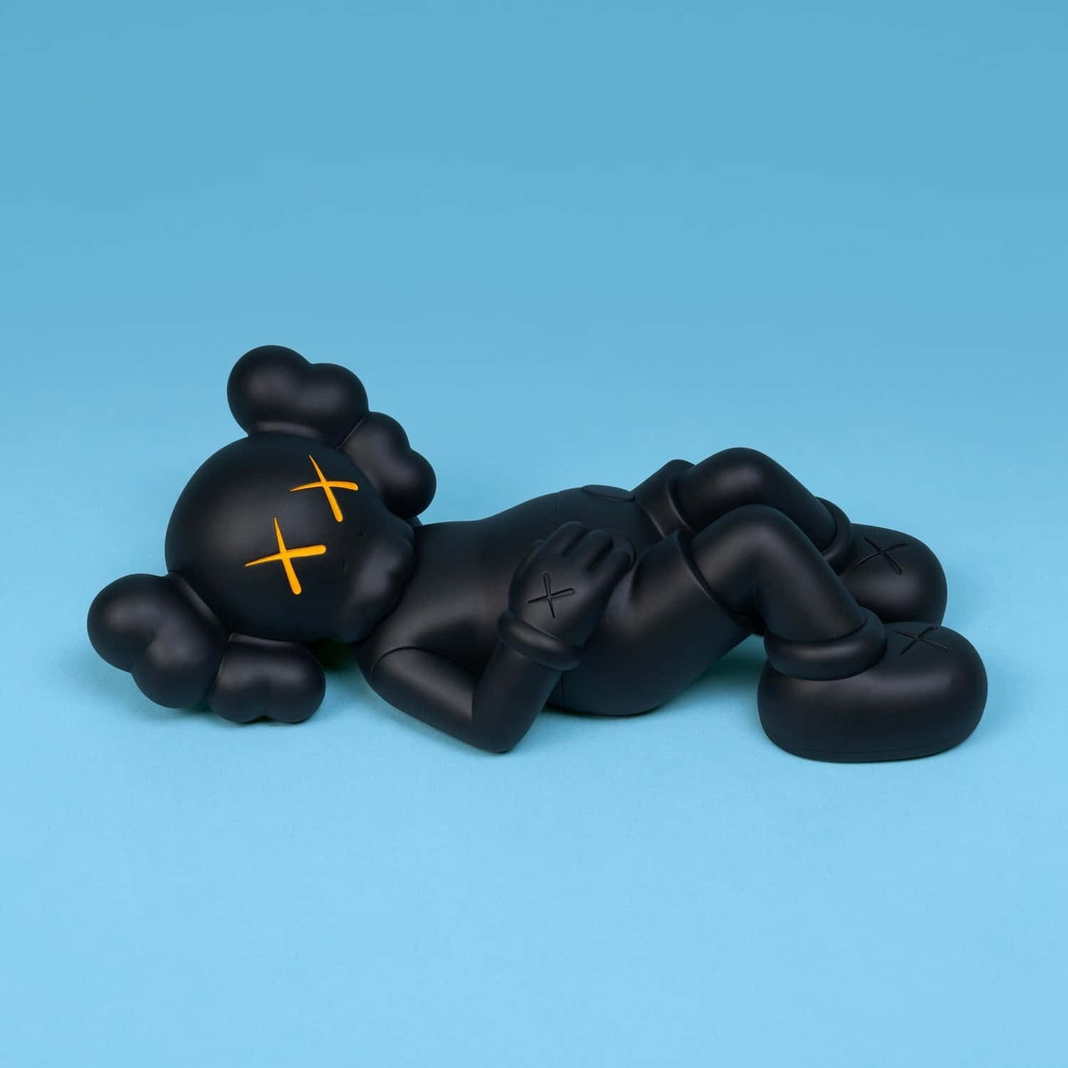 Black Kaws Figure Lying Down Wallpaper