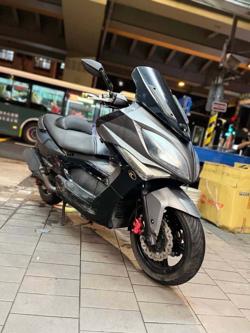 Black Kymco Maxi Scooter Parked Street Wallpaper