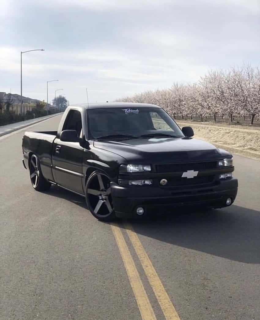 Black Lowered Chevrolet Truck On Road Wallpaper