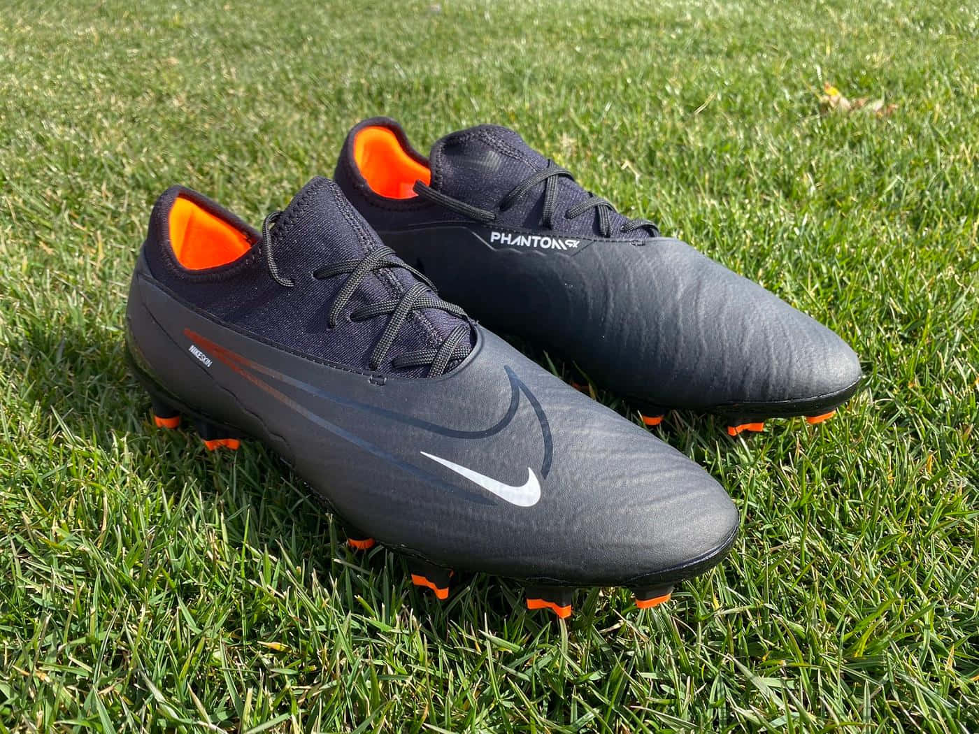 Black Nike Phantom Soccer Cleatson Grass Wallpaper