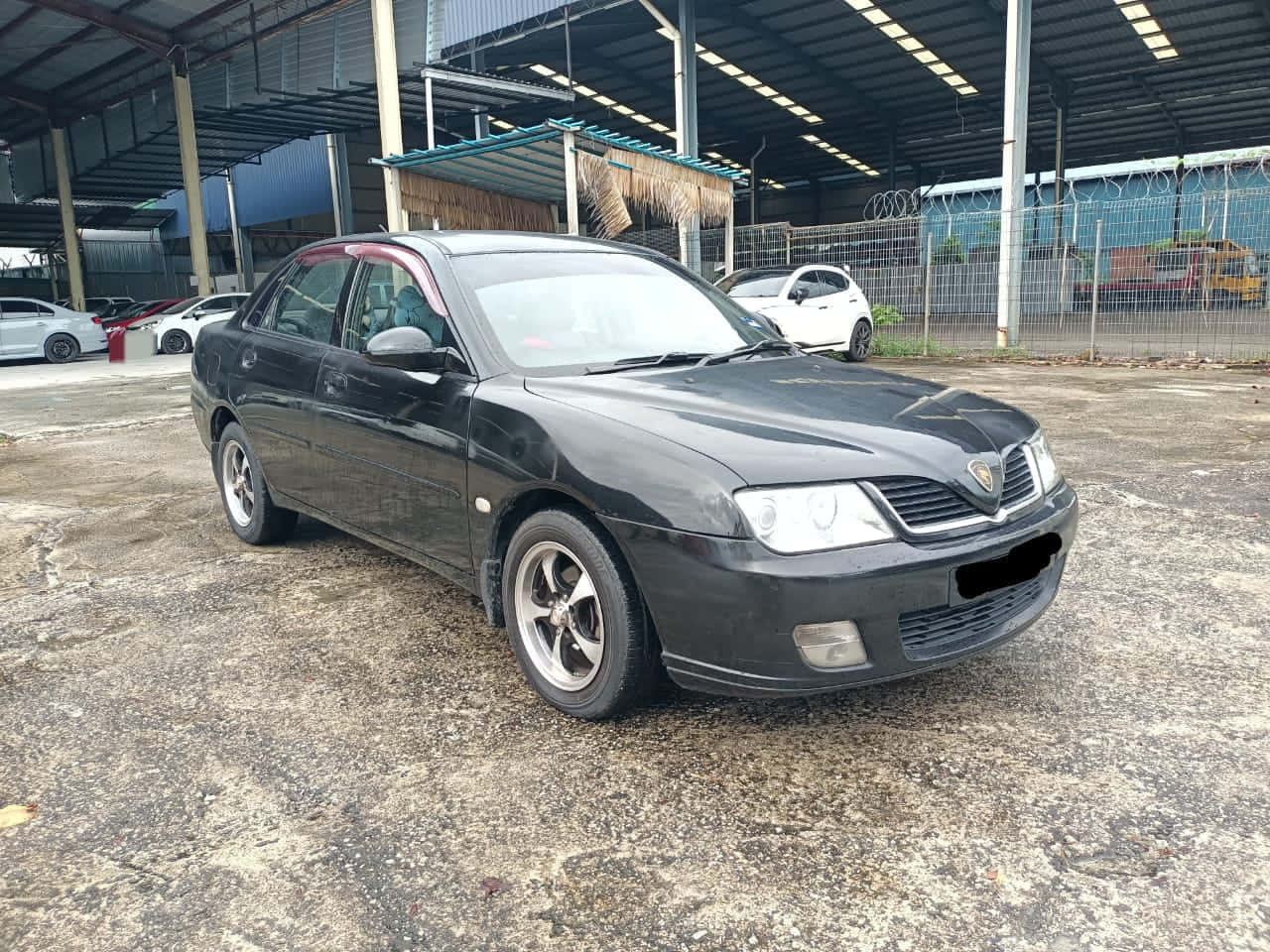 Black Proton Waja Parked Outdoors Wallpaper