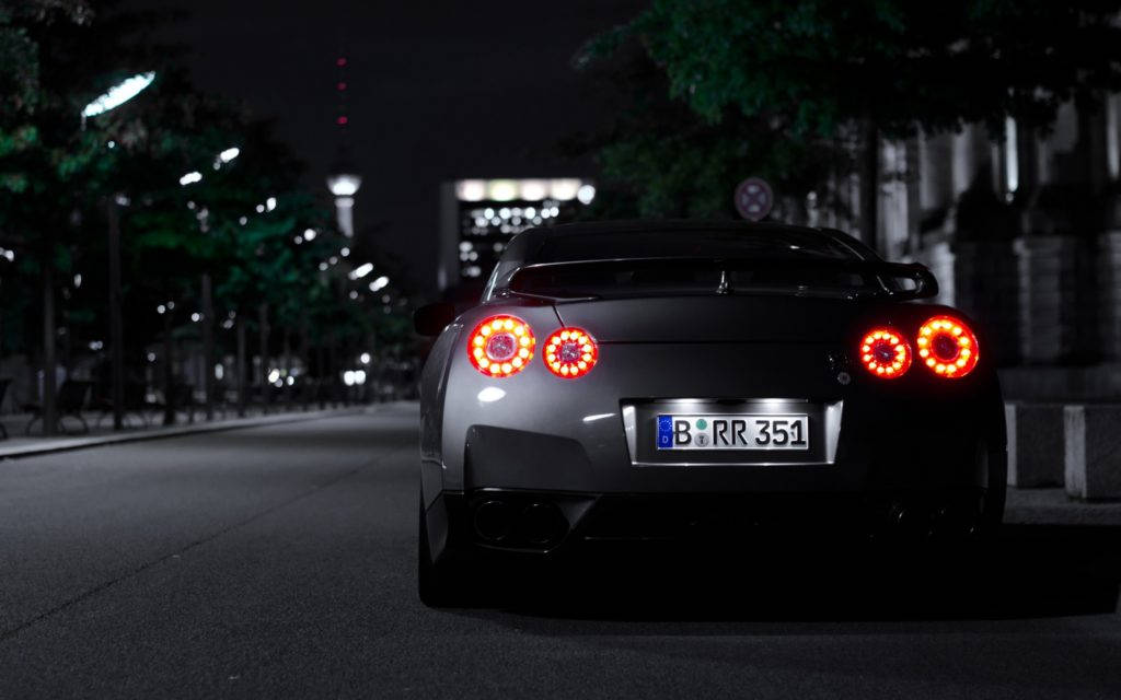 Black Skyline Car Parked In An Urban Street Wallpaper