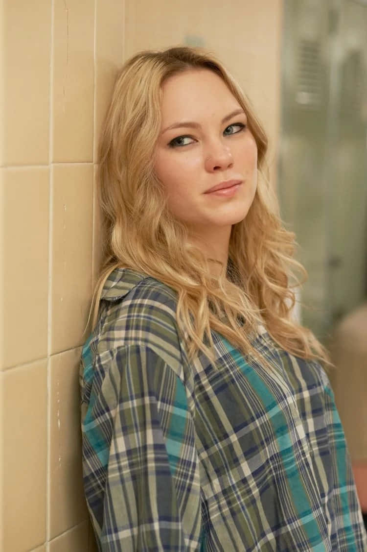 Blonde Woman Leaning Against Tiled Wall Wallpaper