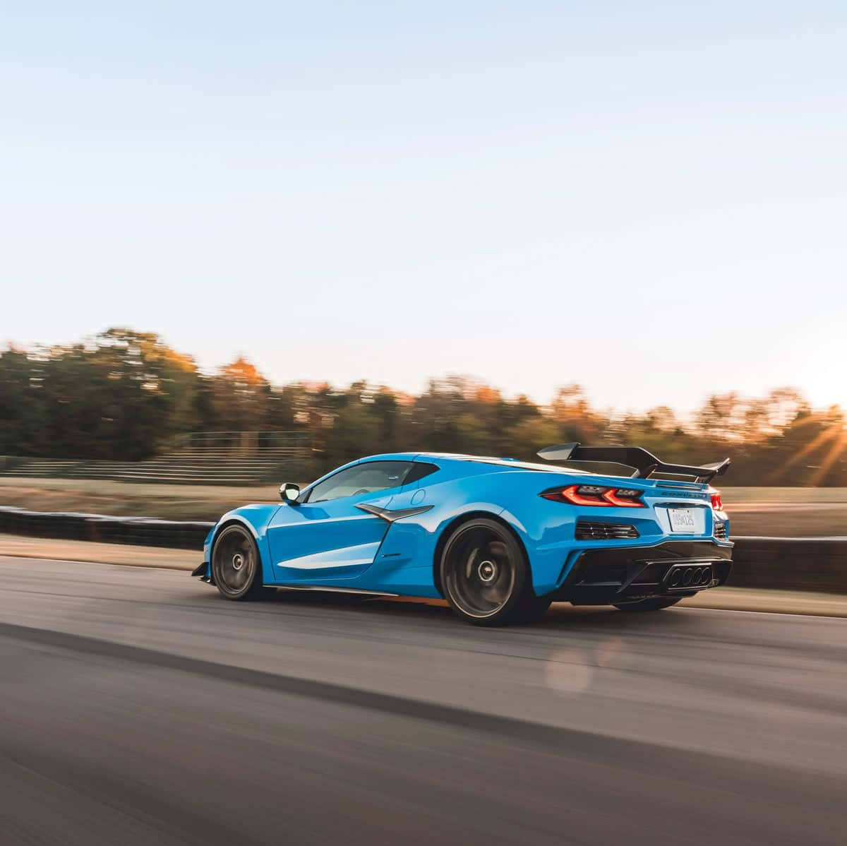 Blue Corvette C8 Speedingon Highway Wallpaper