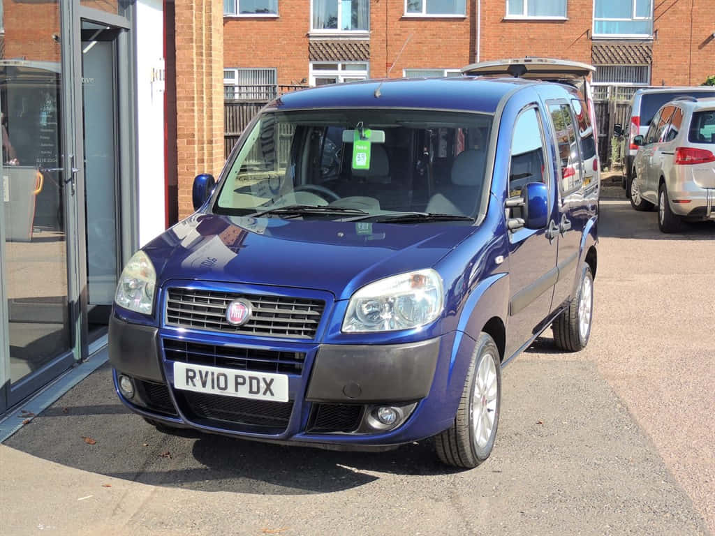 Blue Fiat Doblo Parked Outdoors Wallpaper