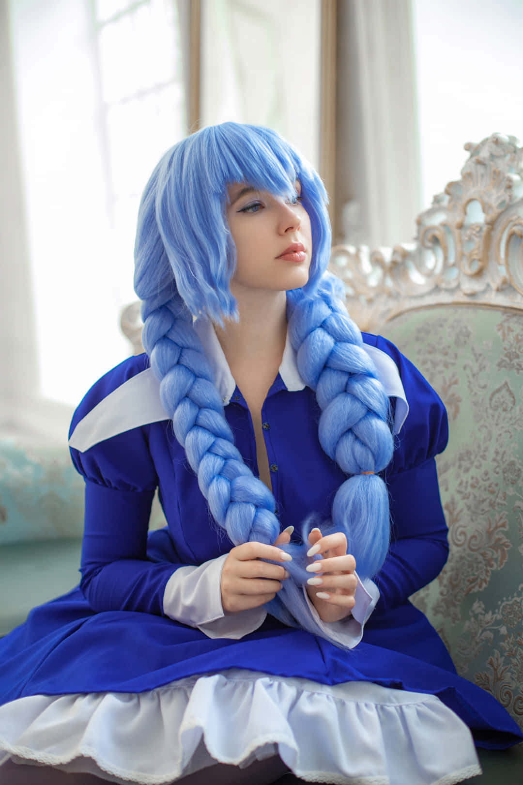 Blue Haired Cosplayer Seated Elegantly Wallpaper