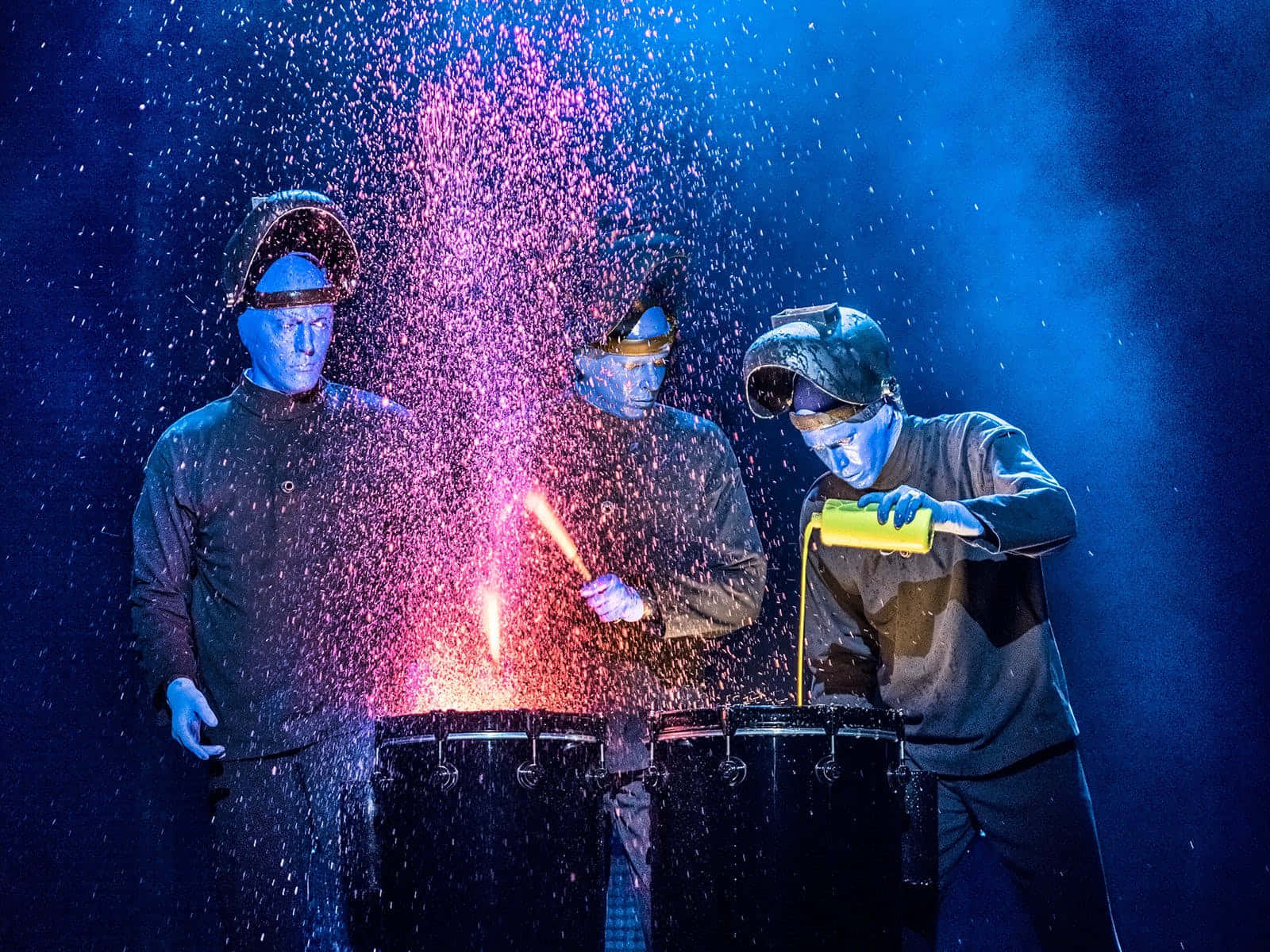 Blue Man Group Performing On Stage Wallpaper