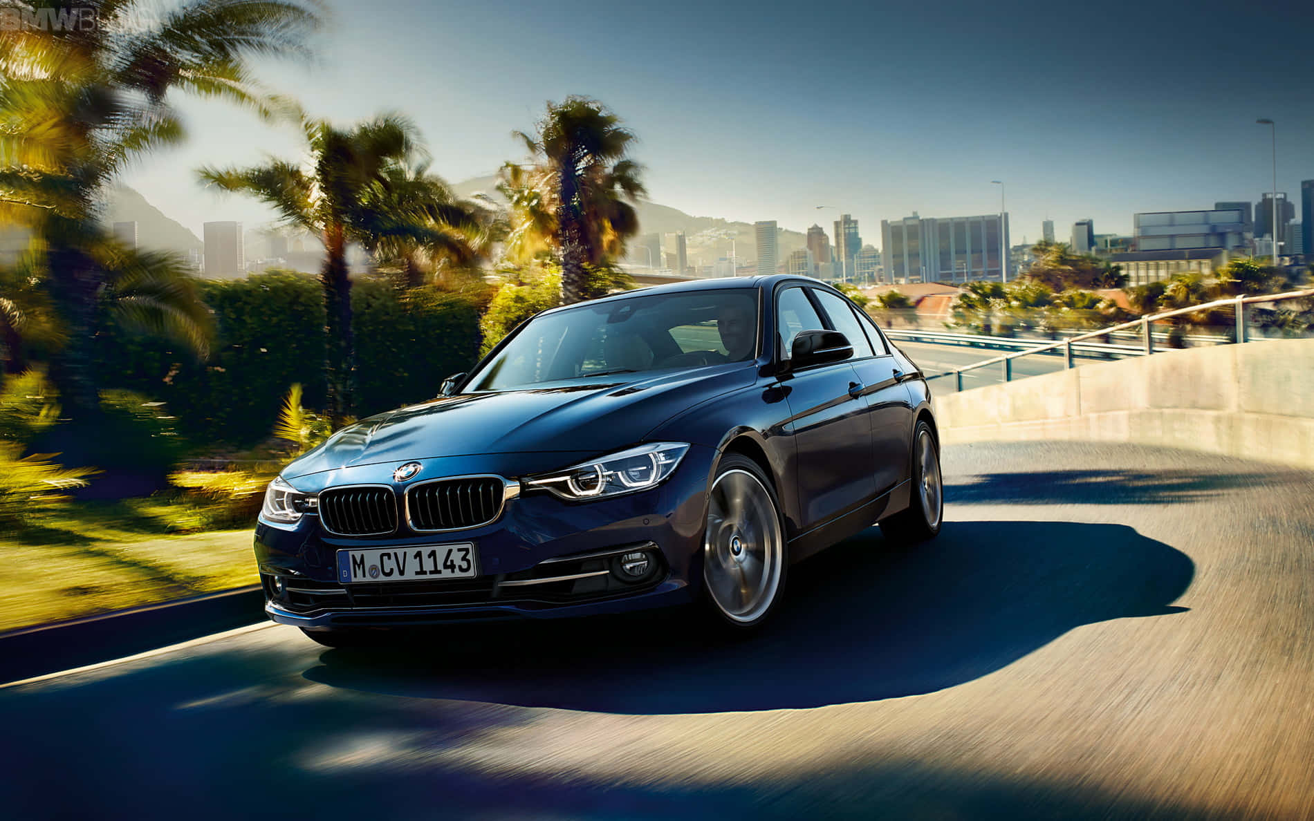 Bmw 3 Series Sedan Driving On A City Street Wallpaper