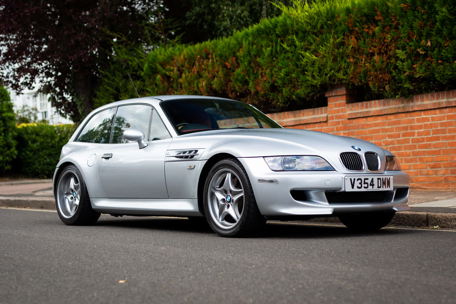 Bmw Z3 Roadster Cruising Down The Road Wallpaper