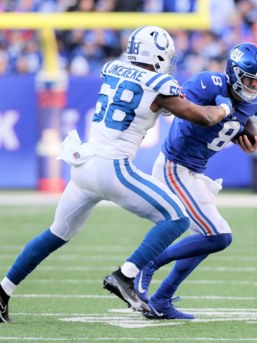 Bobby Okereke In Action During A Football Game Wallpaper