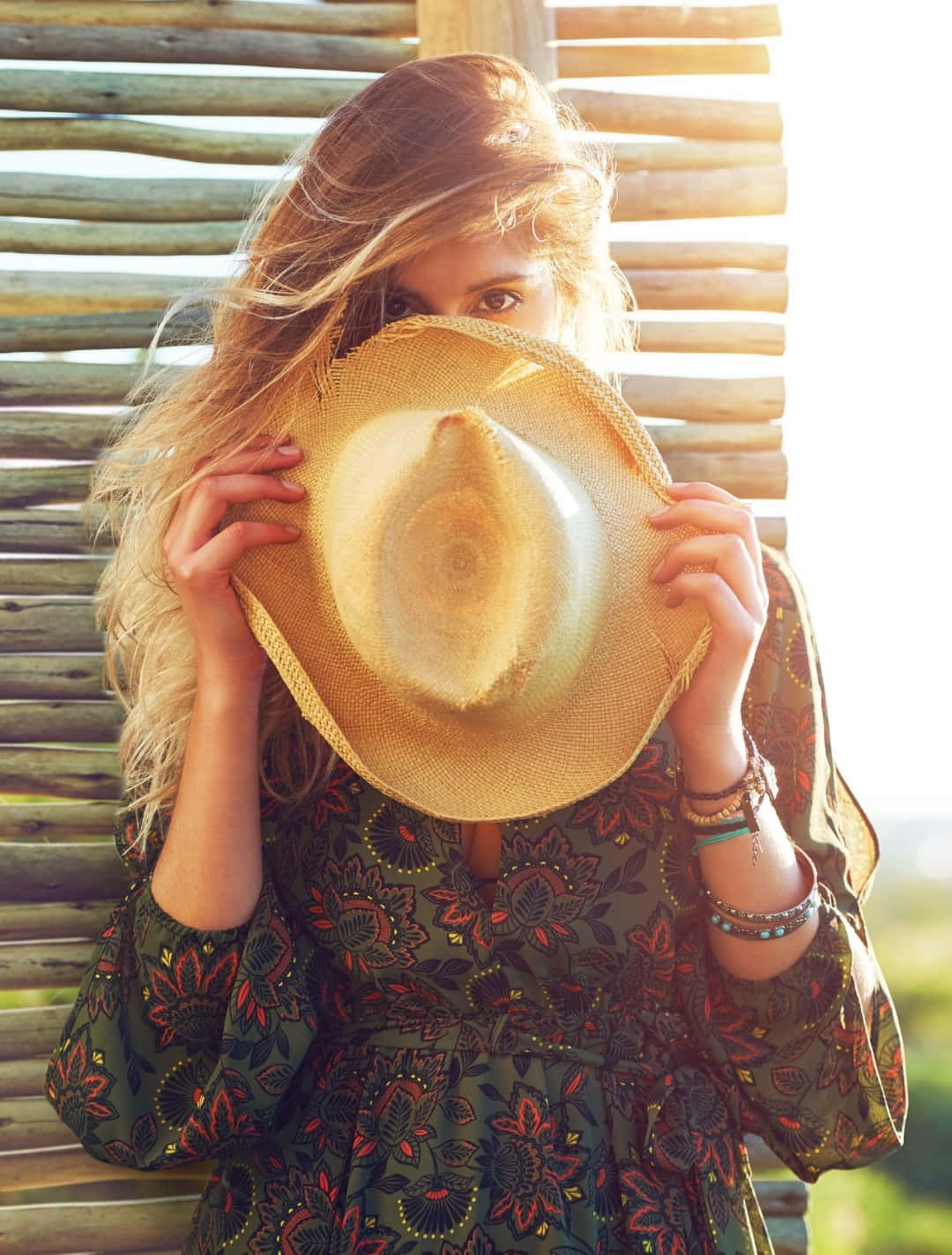 Boho Chic Woman Holding Hat Wallpaper