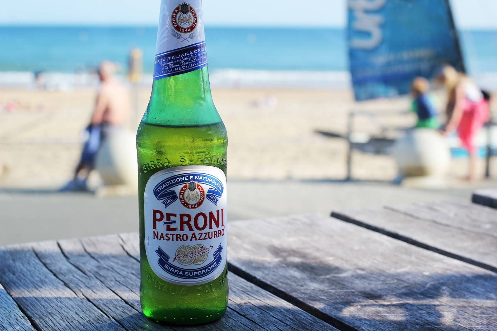 Bottle Of Peroni Beer On A Wooden Plank Wallpaper