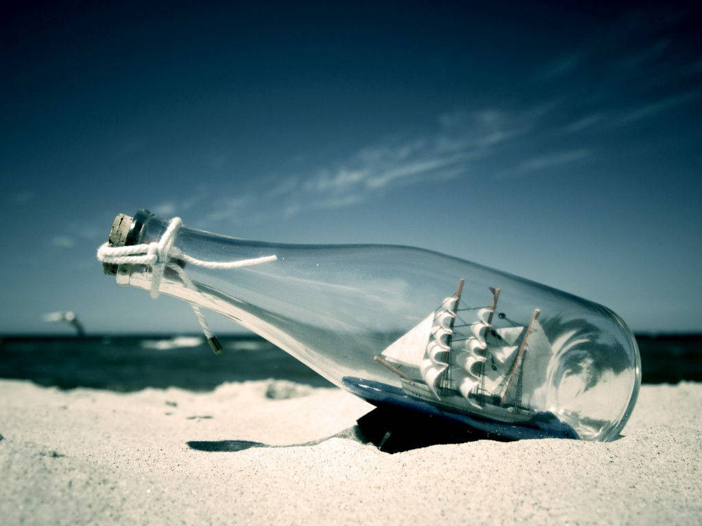 Bottle Ship Sand Laptop Wallpaper