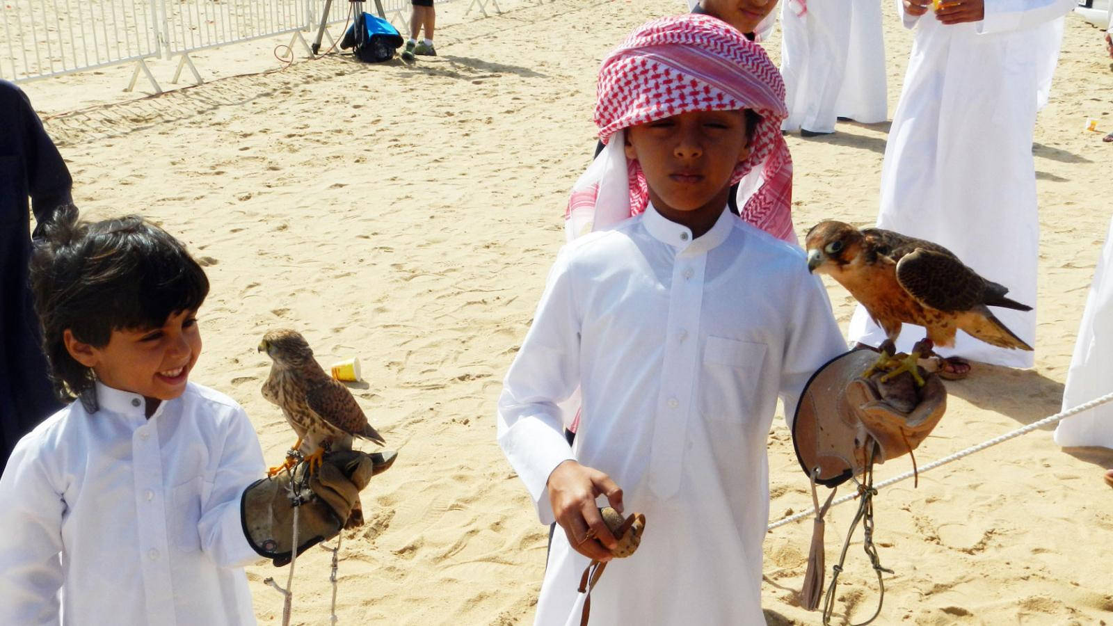 Boys Playing With Qatar's Falcon Wallpaper