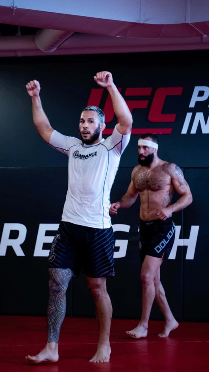 Brad Tavares Cheering In A White Shirt Wallpaper