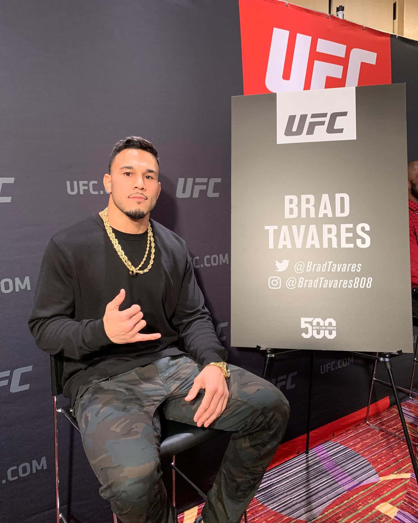 Brad Tavares Posing Next To A Sign Wallpaper