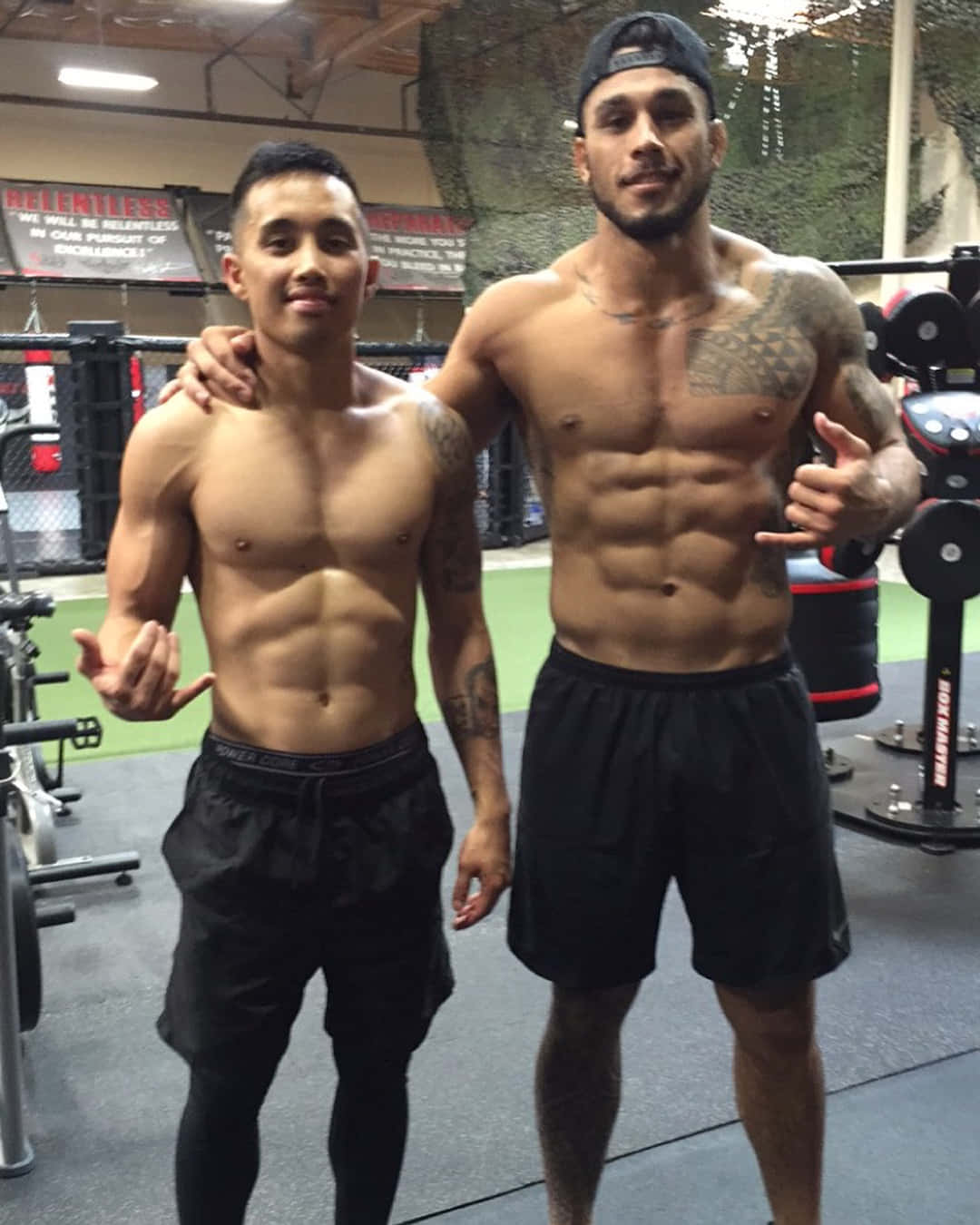 Brad Tavares Posing With Man At The Gym Wallpaper