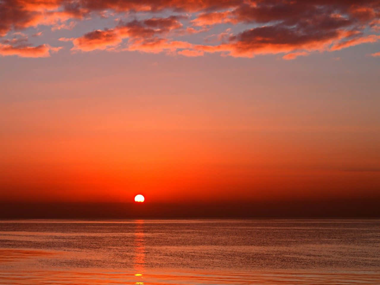 Breathtaking Red Sunset Over The Horizon Wallpaper