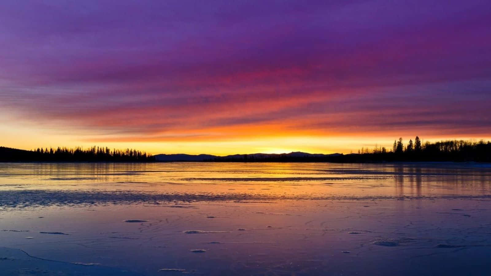 Breathtaking Sunset Reflection On Calm Waters Wallpaper