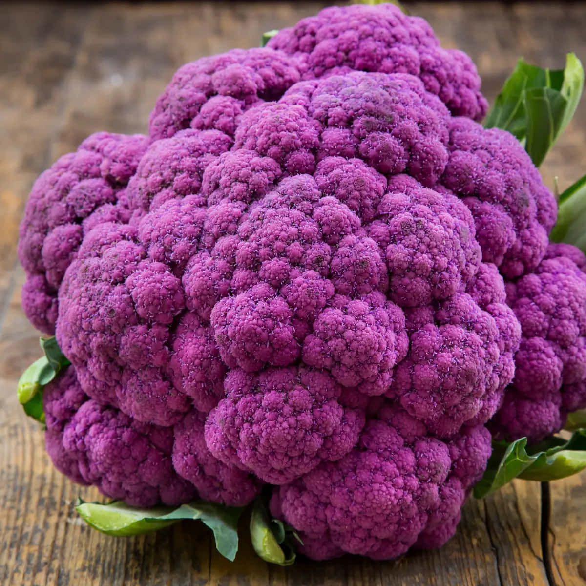 Bright Purple Cauliflower With Green Leaves Wallpaper