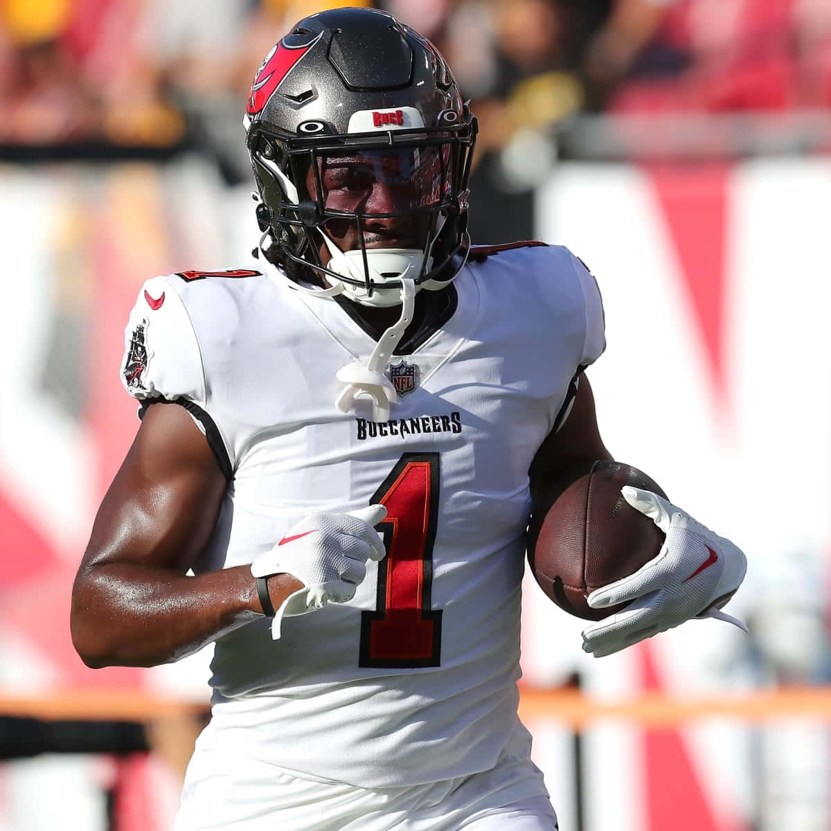 Buccaneers Player Running With Football Wallpaper