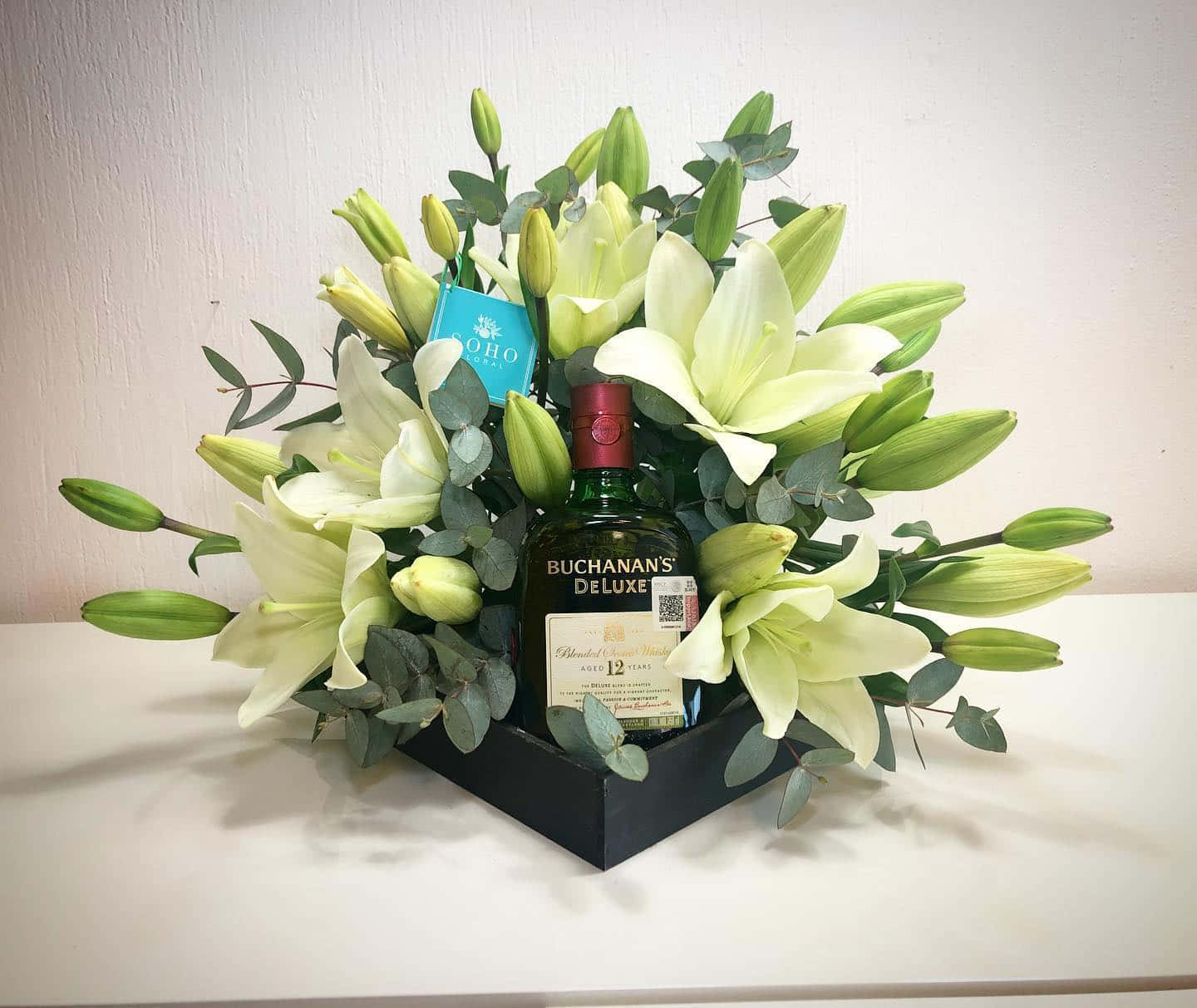 Buchanan's Deluxe Bottle In Flower Arrangement Wallpaper