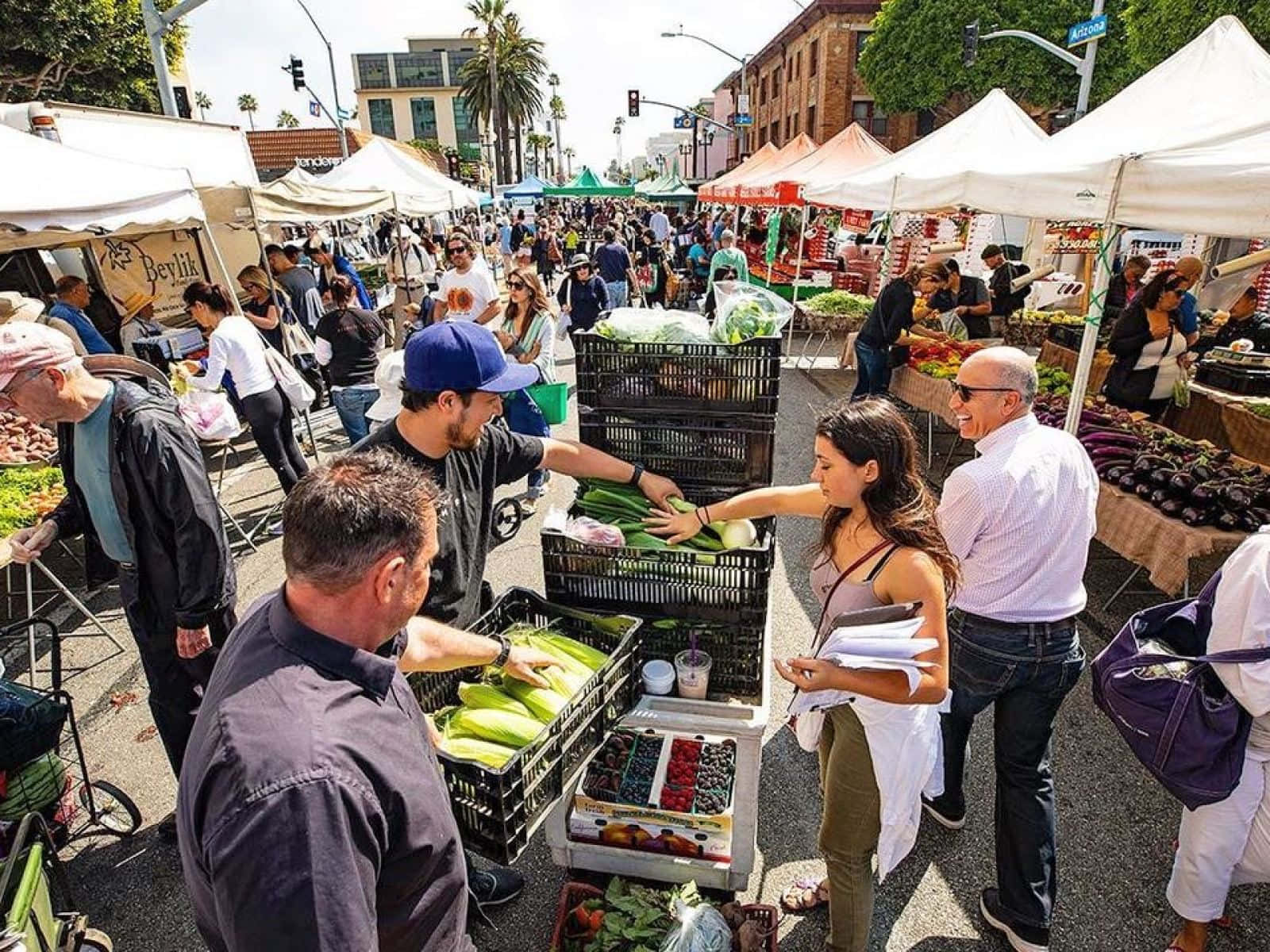 Bustling Farmers Market On A Sunny Day Wallpaper