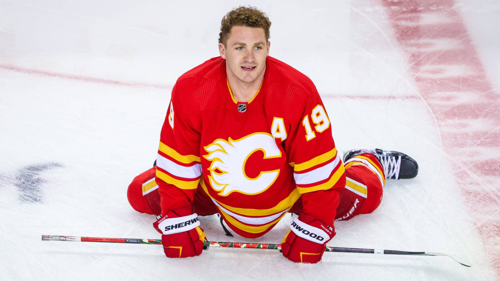 Calgary Flames Matthew Tkachuk Sitting On Rink Wallpaper