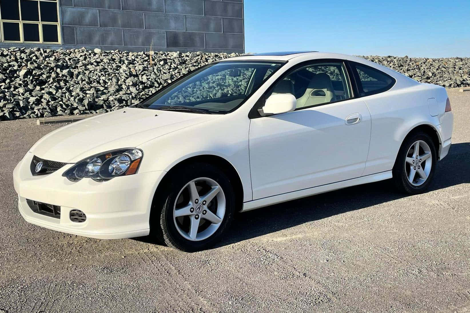 Caption: A Stunning Acura Rsx Sports Coupe On The Open Road Wallpaper