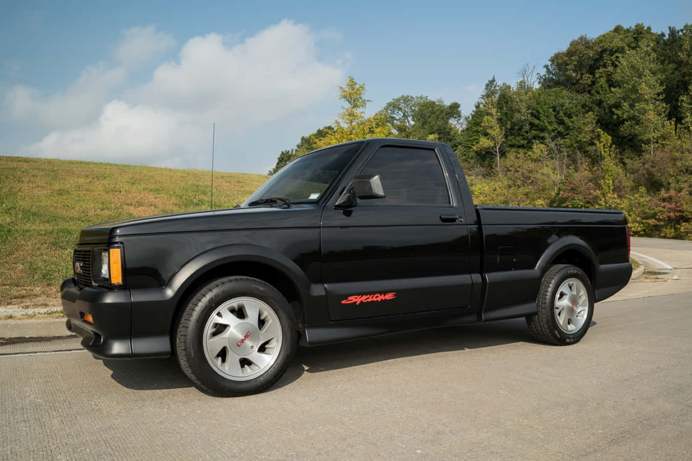 Caption: A Stunning Red Gmc Syclone In Action Wallpaper