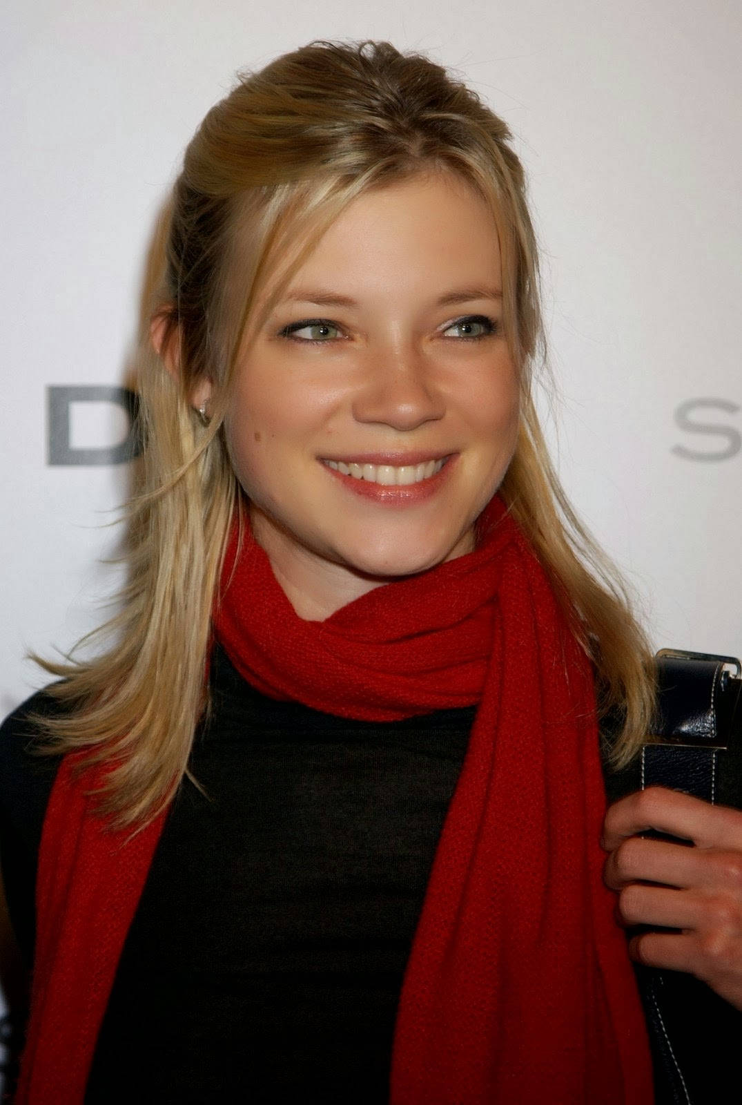 Caption: Amy Smart Radiating Elegance In A Black Dress And Red Scarf Wallpaper