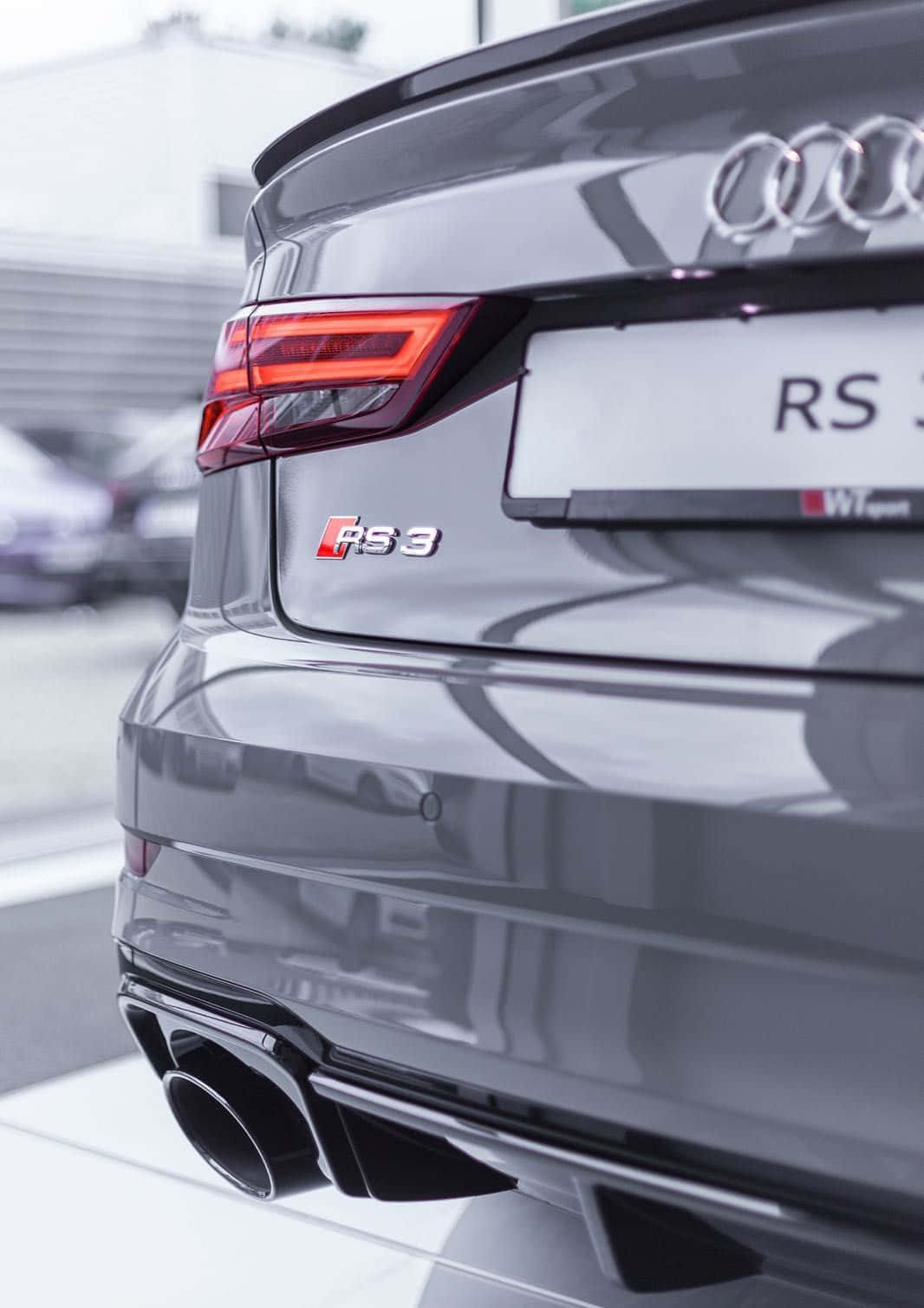 Caption: Audi Rs3 - Dynamic Performance On The Road Wallpaper