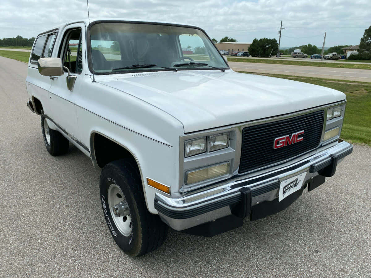 Caption: Classic Gmc Jimmy Suv On Display Wallpaper