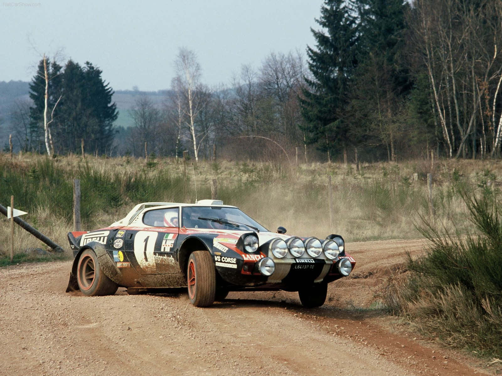 Caption: Classic Lancia Driving On Open Road Wallpaper