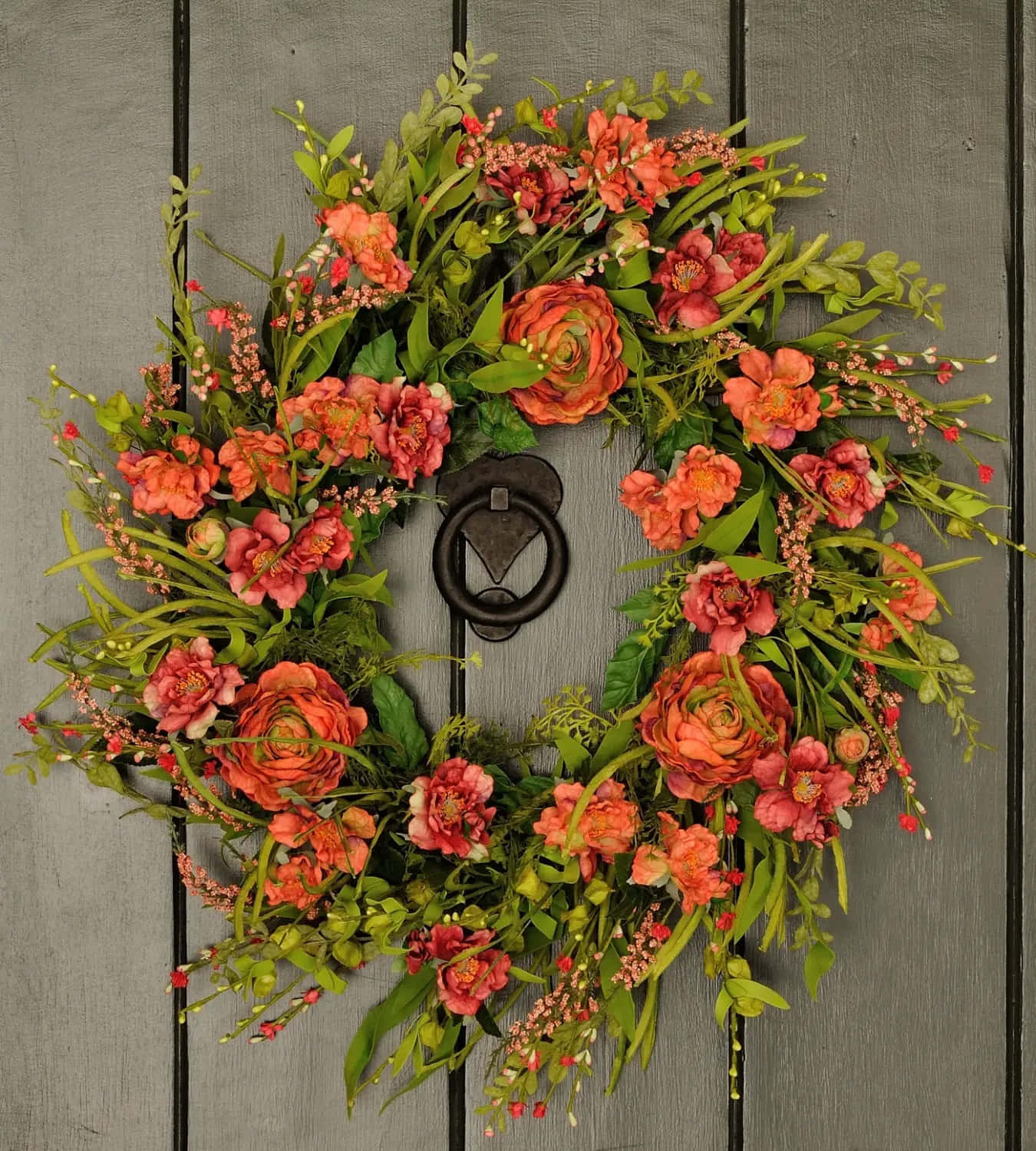 Caption: Colorful Spring Wreath On A White Door Wallpaper